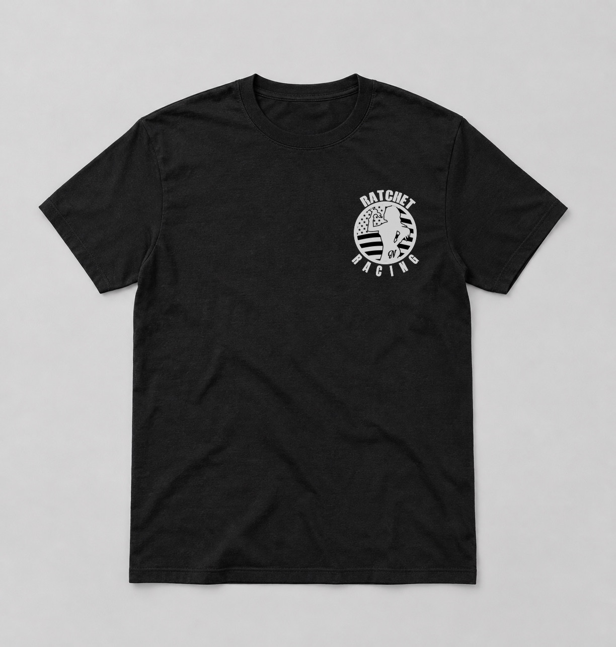 Front view of a black T-shirt with a small white Ratchet Racing chest graphic